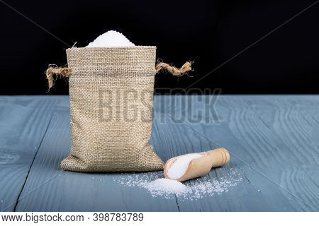 Studio Lighting. Retro Style Wooden Background. Sugar In A Bag Of String. Close-up.