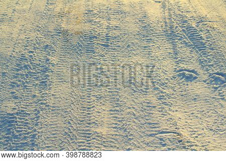 Tire Tracks Left In The Snow On A Bright Sunny Day. The Concept Of Snow Removal, Ski Resorts, Active