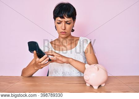 Beautiful brunettte woman caculating money savings skeptic and nervous, frowning upset because of problem. negative person. 
