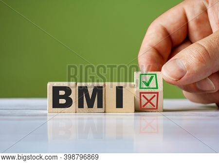 The Hand Turn Wooden Block With Red Reject X And Green Confirm Tick As Change Concept Of Bmi. Word B