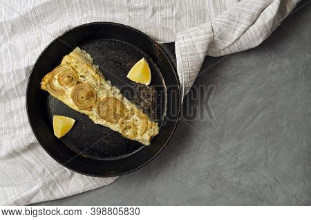 Fried Baked Mackerel Trachurus With Onions And Dried Herbs In An Old Frying Pan In A Towel. Rustic R