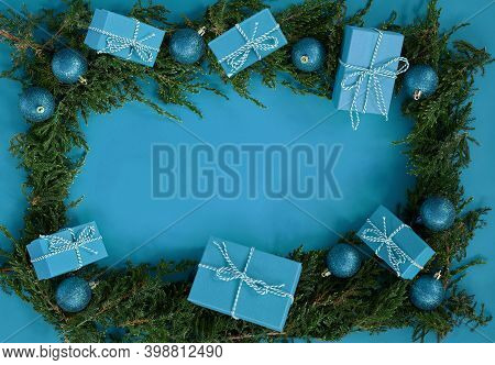 Fflat Lay New Year Christmas Blue Boxes, Blue Balls, Pine Tree On Blue Background. High Quality Phot