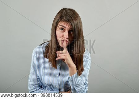 Index Finger On Lips, Silence Gesture, Shhh Quiet, Asks For Voicelessness Forefinger At The Mouth. Y