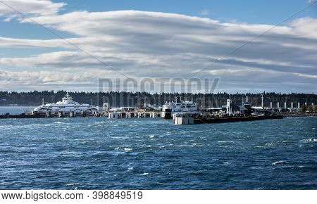 Passenger Ferry Terminal With Two Large Ferry Ships In Windy Weather And Stormy At A Background Of S