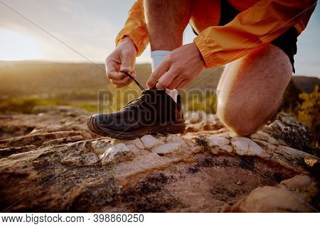 Closeup Of Hands Of Fit Male Jogger Tying Shoelaces Preparing For Cross Country Mountain Trail Run I