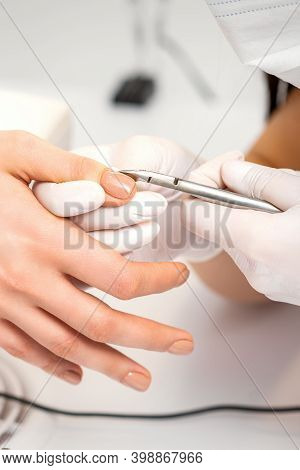 Manicure Master Is Removing Cuticles With A Nail Clipper In A Nail Salon