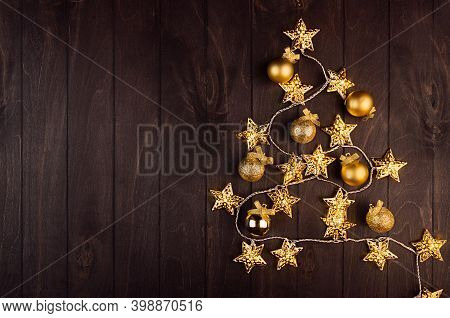 Bright Festive Background - Golden Christmas Tree Of Balls, Stars Glowing Of Electric Lights On Eleg
