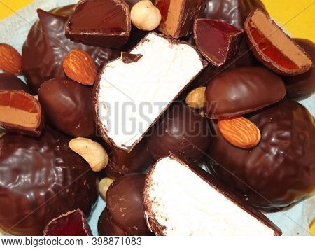 Chocolate Candies, Marshmallows, Marmalade And Various Nuts Close-up. High Quality Photo