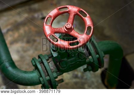 Industrial Chemical Petrochemical Retro Style Green Valve Closeup With Selective Focus On Red Steeri