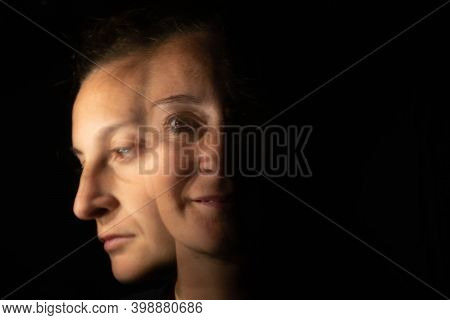 Dark Portrait Of A Smiling Woman With Only Half Her Face Lit Up On A Black Background That Unfolds I