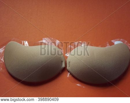 Beige Strapless Bra Close-up On Different Color Backgrounds, Size A. High Quality Photo