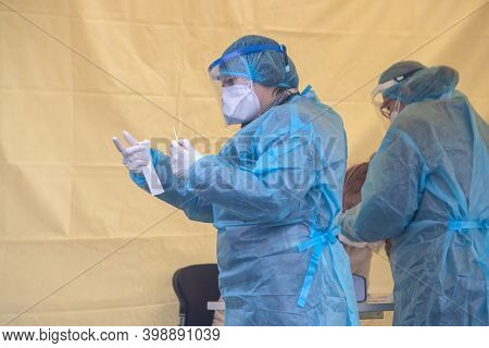 A Medical Worker Wearing Special Suit To Protect Against Coronavirus, Conduct A 