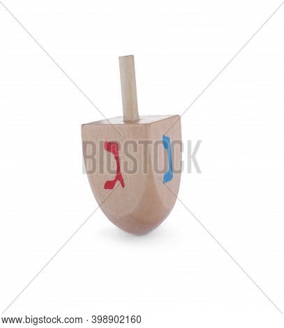 Wooden Hanukkah Traditional Dreidel With Letters Nun And Gimel Isolated On White