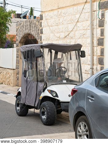 Nazareth, Israel, December 05, 2020 : Muslim Circassian Woman Sits In An Electric Car In The Muslim 