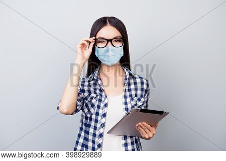 Portrait Of Nice Smart Youth Girl Wearing Safety Mask Using E-book Studying Remotely Infection Preve