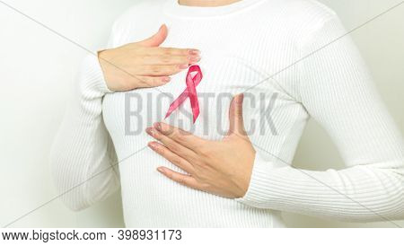 Closeup Of Woman With Pink Ribbon Like Cancer Awareness Symbol. Support Breast Cancer And Tumor Pati