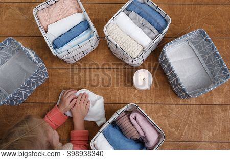 A Group Of Organic Cotton Clothing Laid Out On A Wooden Background Is Ready To Be Folded Into White 