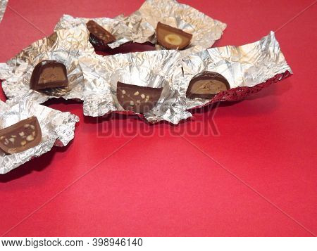 Individual Silver Wrapped Chocolates With Different Fillings In A Box. High Quality Photo
