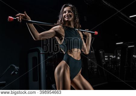 Charming Girl Posing With A Bodybar. The Concept Of Fitness, Bodybuilding And Healthy Lifestyle.