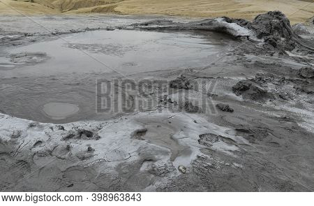 Bubbling Crater Of A Mud Volcano. Close Up View Onto Gas Bubble Exploding In Crater Of Mud Volcano. 