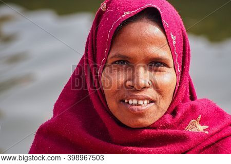 Varanasi, India - Dec 26, 2019: Unidentified Indian Woman With Her Colorful Scarf. Scarf Made Of Ind