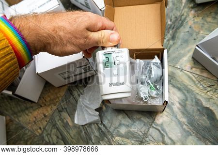 Paris, France - Oct 25, 2020: Pov Man Hand Unboxing Package Of Vaillant Ambisense Vr50 Thermostatic 