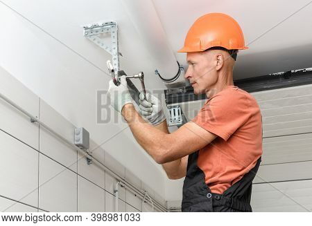 Worker Is Installing Lift Gates In The Garage.