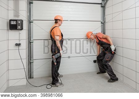The Workers Are Installing Lift Gates In The Garage.