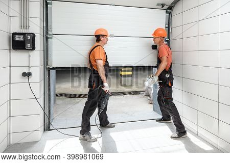The Workers Are Installing Lift Gates In The Garage.