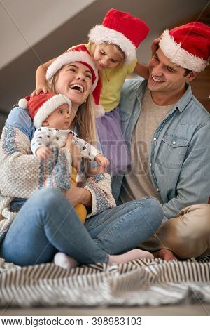 Happy parents spening Christmas time together with their kids
