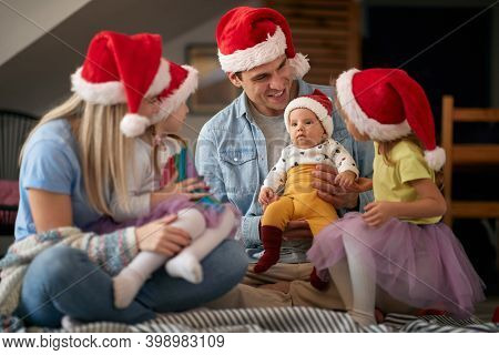 Joyful parents spening Christmas time together with their kids
