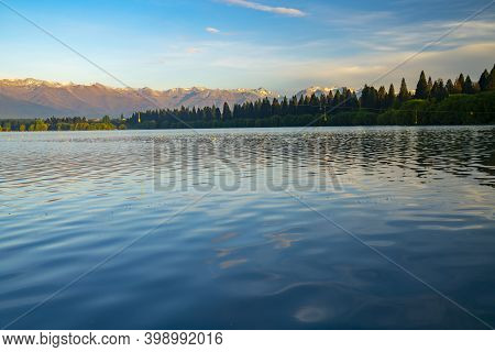 The Golden Hour Over Lake Ruataniwha As Rising Sun Catches Rowing Course Buoys And Floats And Casts 