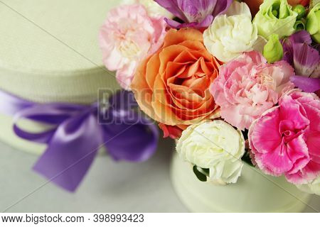 White Gift Box Decorated Purple Ribbon And Bouquet Of Beautiful Flowers. Wedding Gift. Birthday Gift