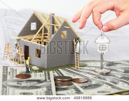Family house with money and key. Construction background.