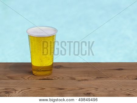 Golden Lager Or Beer In Disposable Plastic Cup
