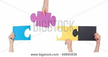 People Holding A Puzzle