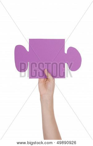 Hand Holding A Piece Of A Puzzle