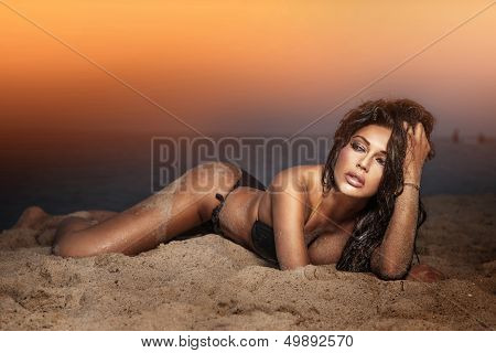 Sensual Brunette Beauty Posing On The Beach.
