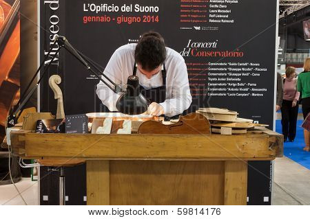Luthier Working On A Violin At Bit 2014, International Tourism Exchange In Milan, Italy