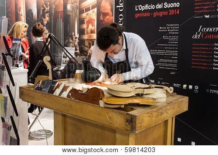 Luthier Working On A Violin At Bit 2014, International Tourism Exchange In Milan, Italy