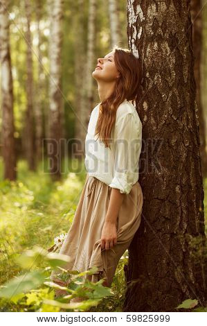 Woman Leaning Against Birch And Resting