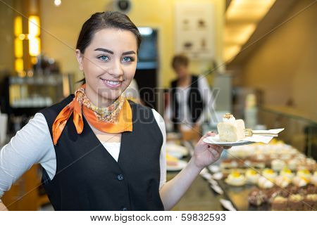 Waitress Presenting Cake In Cafe Or Confectionery