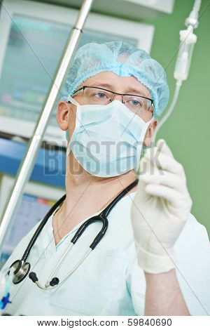 anaesthesiologist doctor in uniform preparing narcosis anaesthesia during heart transplantation operation at cardiac surgery clinic