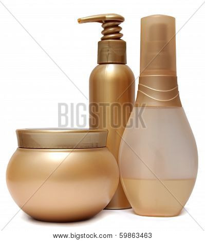 Three Golden plastic jars and bottles isolated on white background.