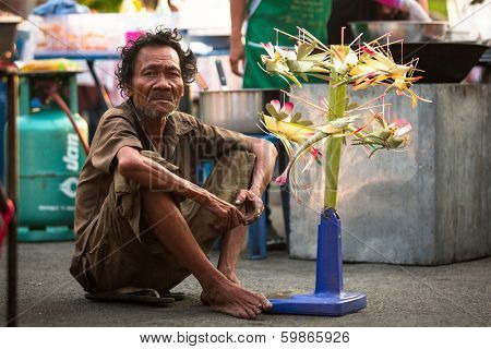 AYUTTHAYA, THAILAND - MAR 11: An unidentified beggar sells handicrafts near Ayutthaya Historical Park on Mar 11, 2012 in Ayutthaya, Thailand.