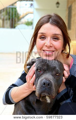 Young Women Smiling With A Black Dog