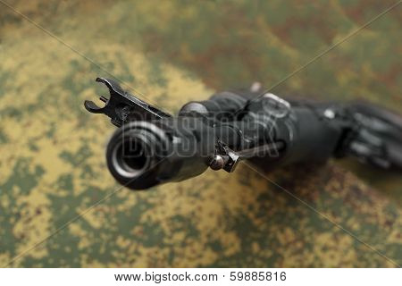 Assault Rifle View From Muzzle Brake Focus On Front Sight On Camouflage