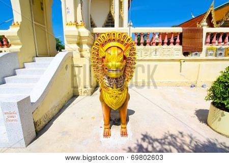 Ratchaburi, Thailand - April 20, 2014:lion statue at temple Thailand.,The beautiful temple roof and blue sky in Ratchaburi, Thailand on April 20, 2014