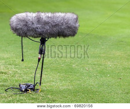 A Large Microphone Boom With Windshield