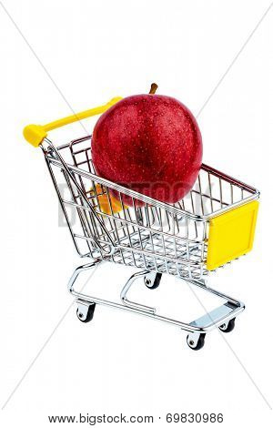 an apple is in a shopping cart. symbolic photo for the purchase of healthy, vitamin-rich foods.